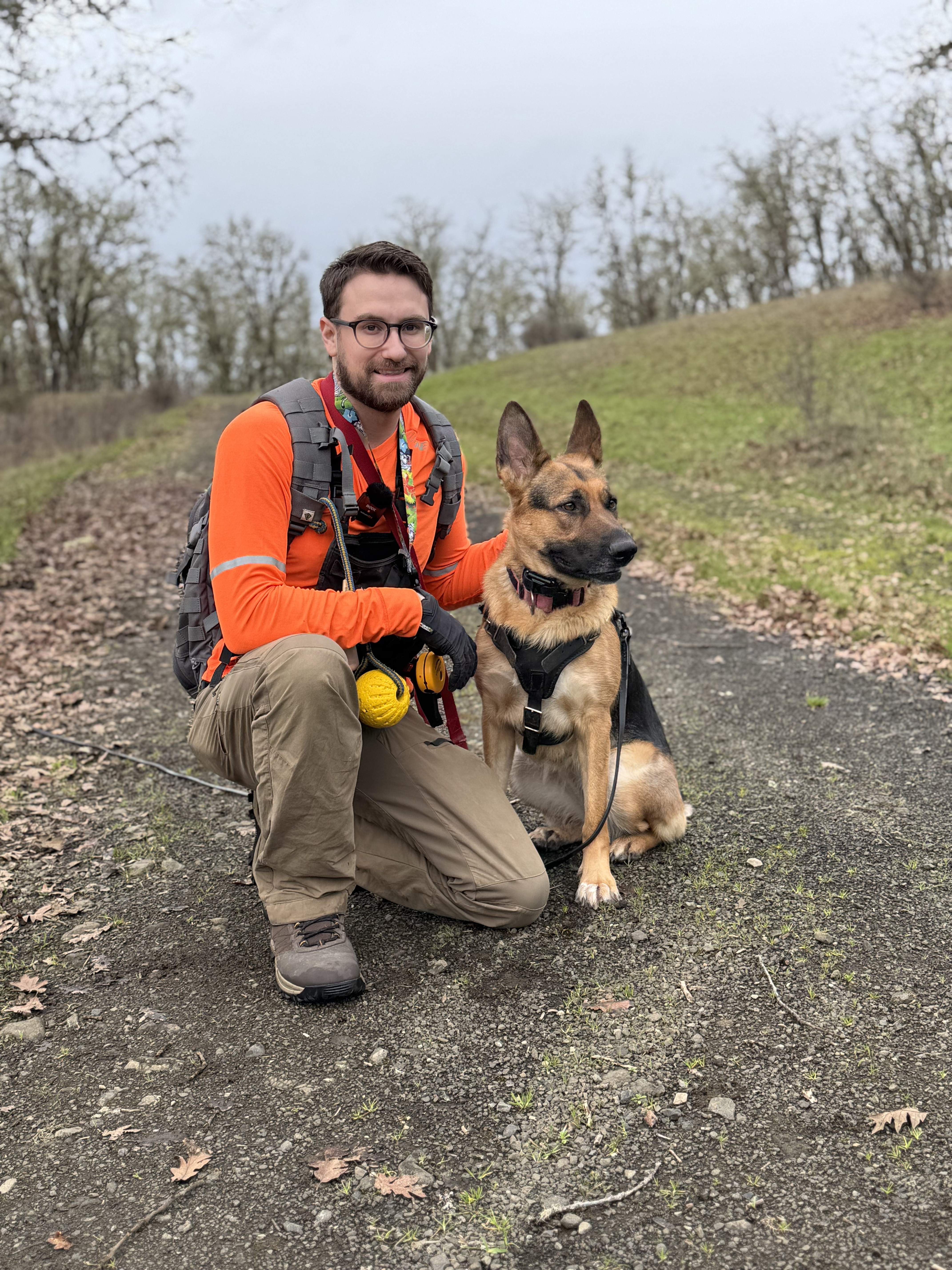 Trainer with Nala during search and rescue field training